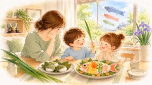 鯉のぼりが見える窓辺で、母と2人の子が柏餅と鯉の形のちらし寿司を前に、菖蒲の葉を持って笑っている