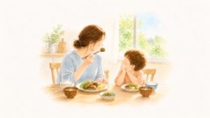 ピーマンの肉詰めをおいしそうに食べる大人を、隣でじっと見る子ども